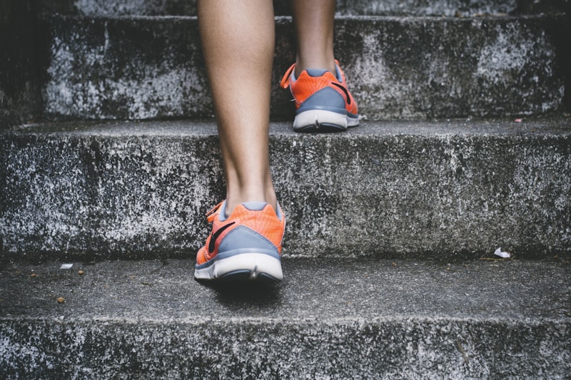 Person climbing outdoor concrete steps during a morning movement routine